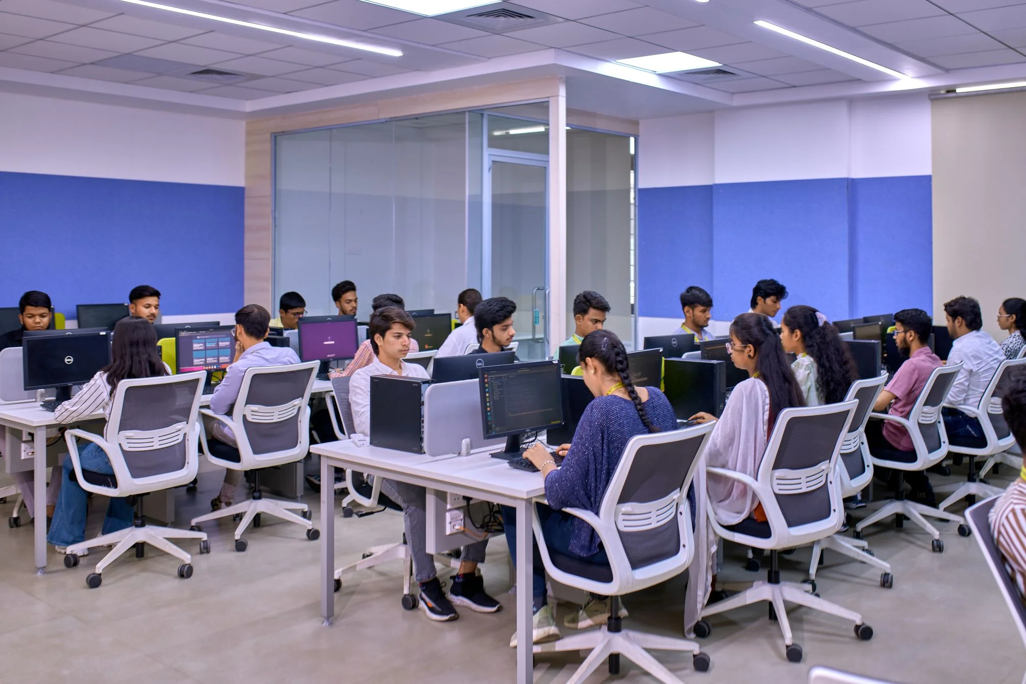Students sitting in front of computers in a computer lab.
