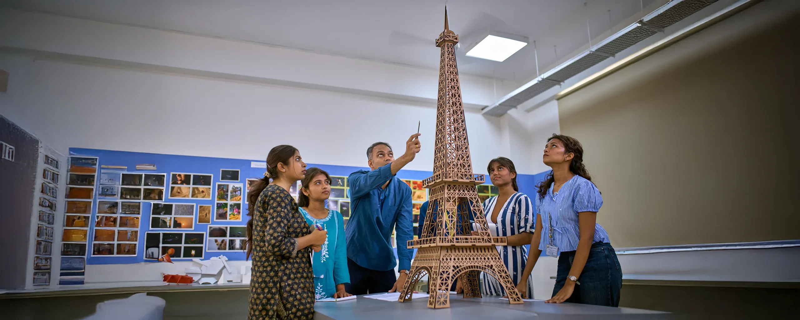 A student showcasing a design by hand.